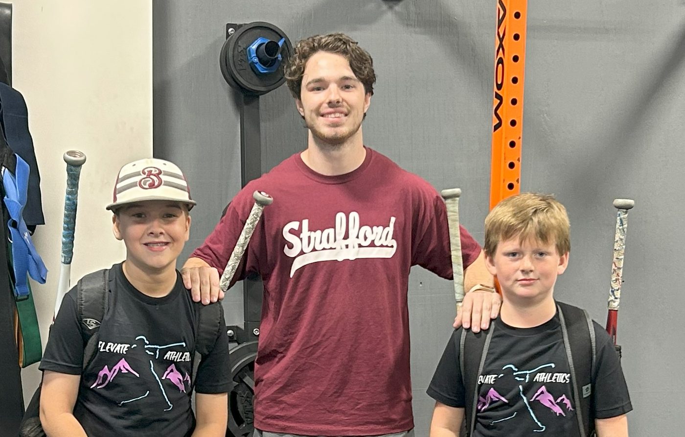 Driveline-certified pitching coach with young athletes at Elevate Athletic Training